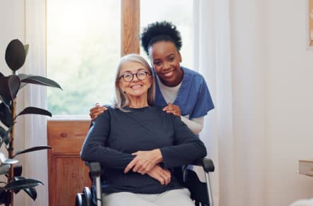 nurse and old woman with wheelchair