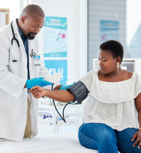 a doctor checking blood pressure of a patient